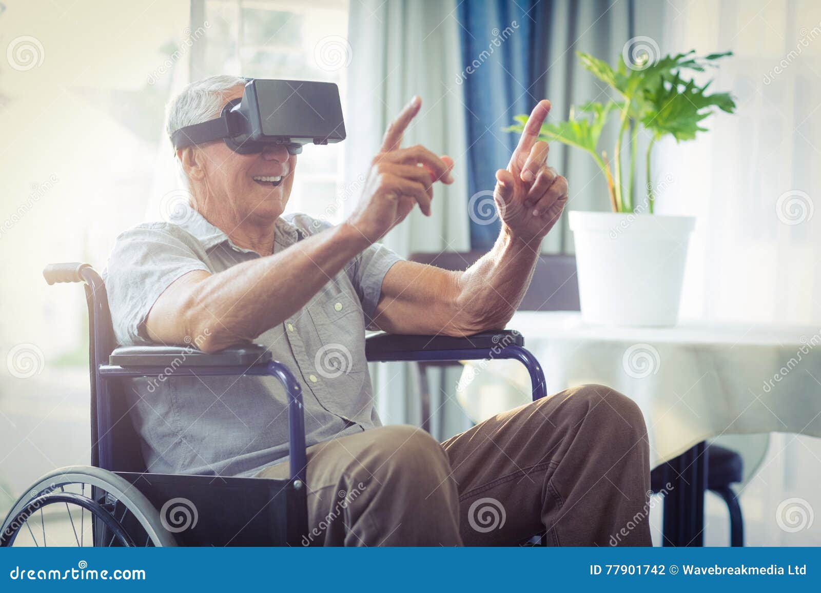 happy senior man on wheelchair using vr headset