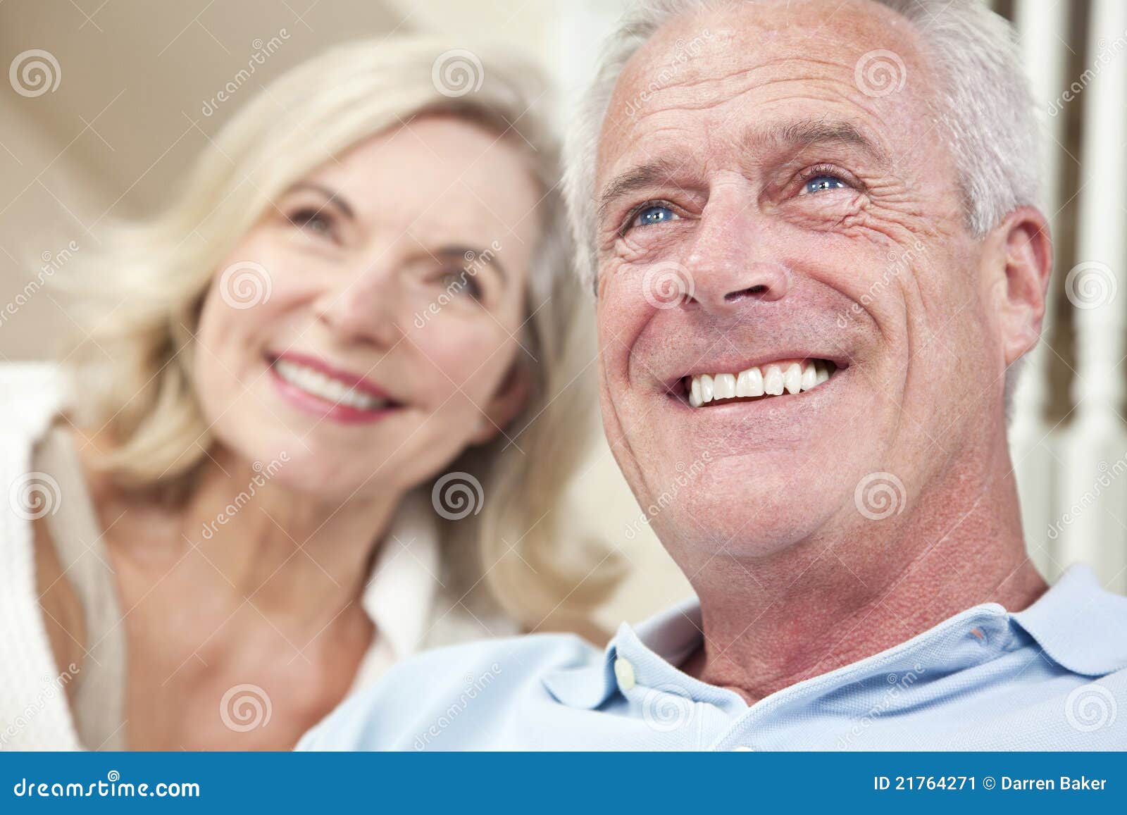 happy senior man & woman couple smiling at home