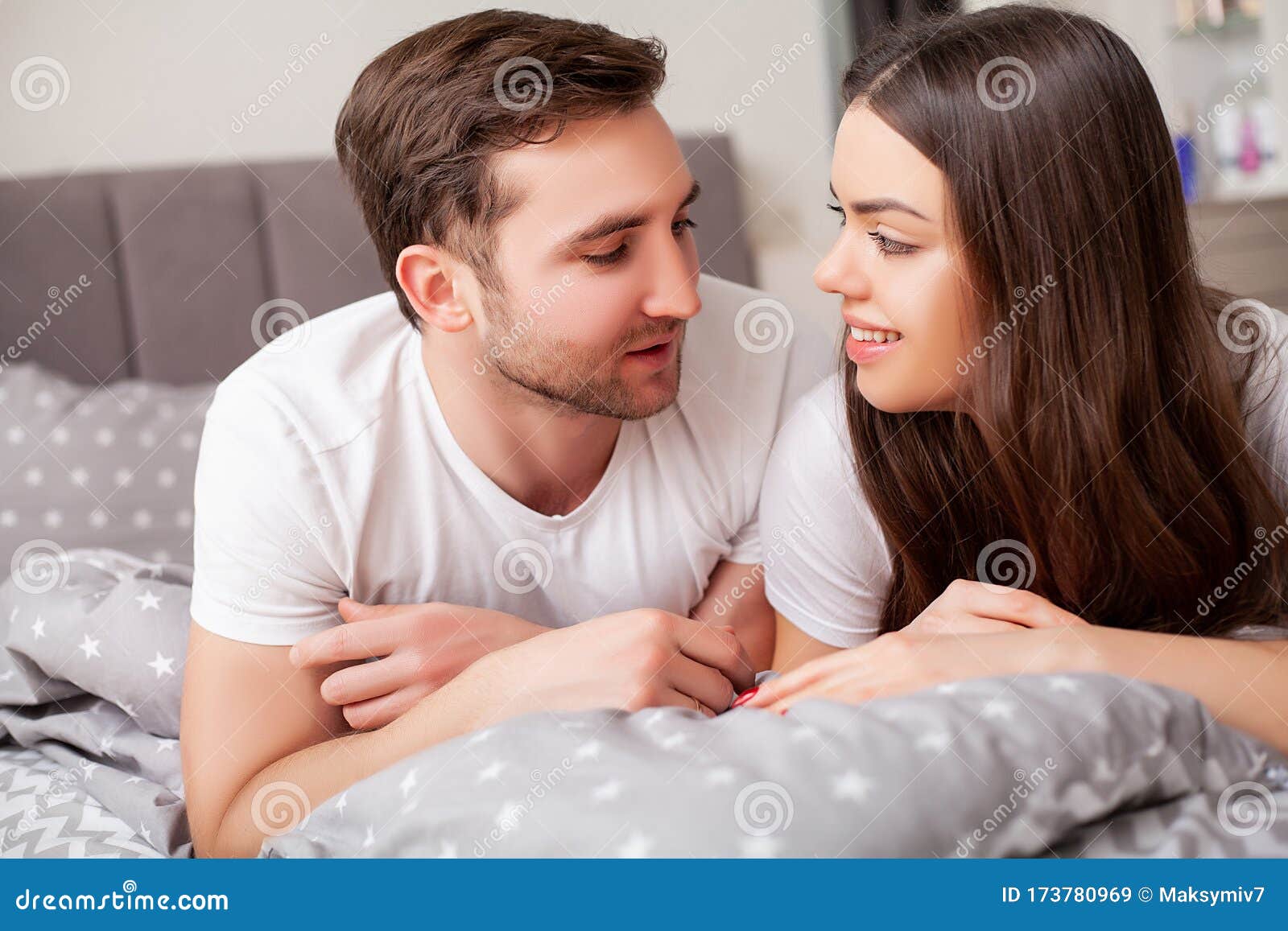 Happy Sensual Young Couple Lying In Bed Together Stoc