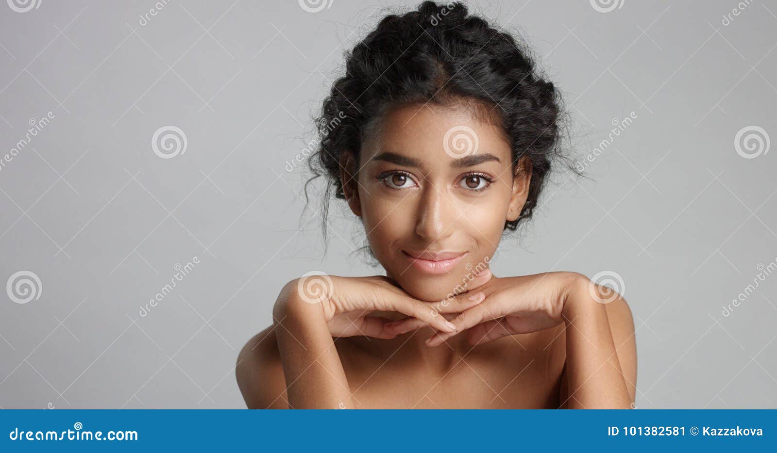 Happy Serene Young Woman With Beautiful Olive Skin And Curly
