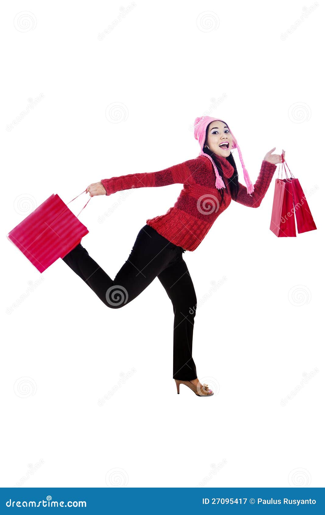 Happy shopper isolated in white. Excited woman shopper carrying shopping bags isolated in white