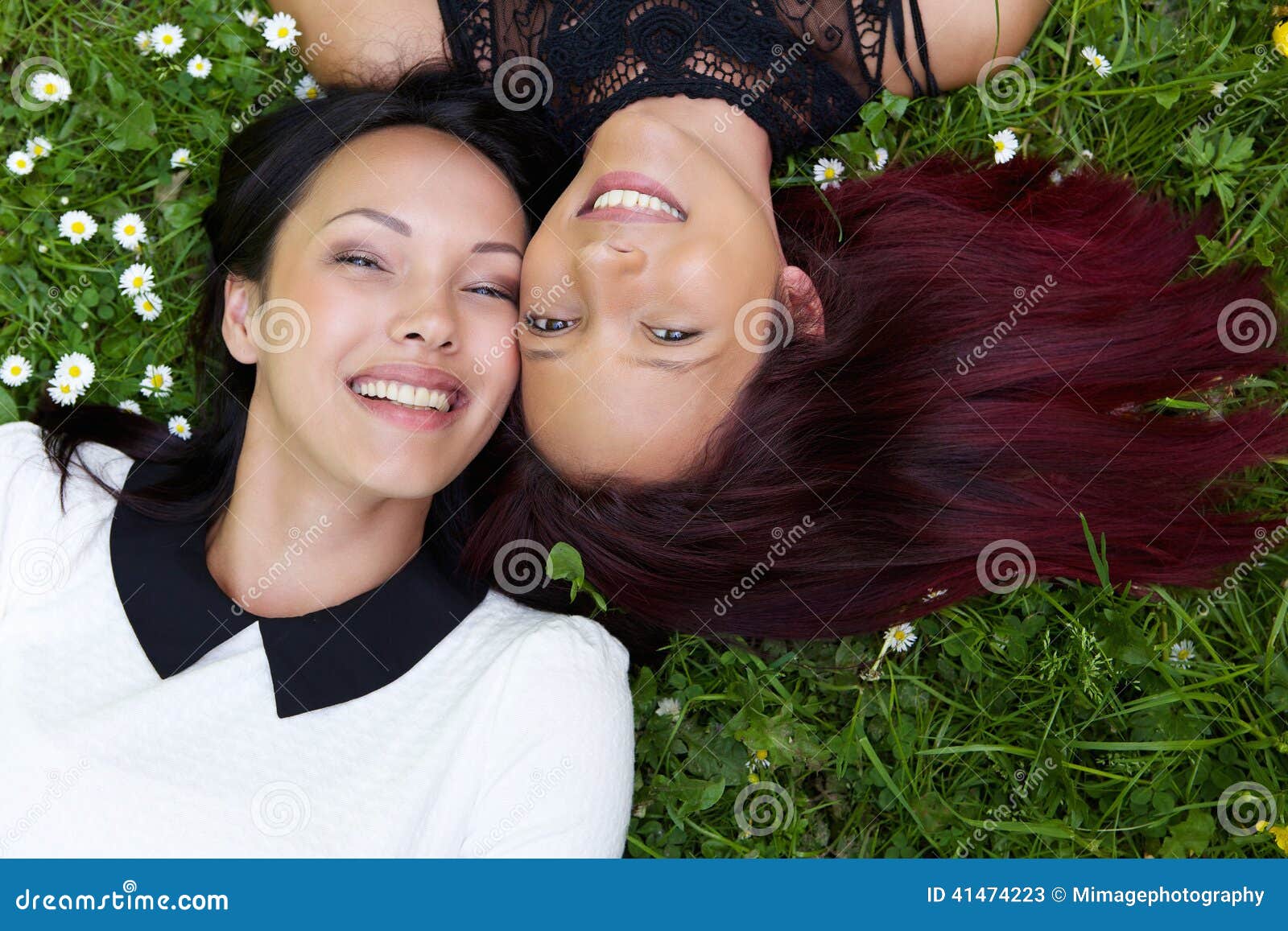 Happy Sisters Lying On Grass Outdoors Stock Image Image Of Mixed Nature 41474223