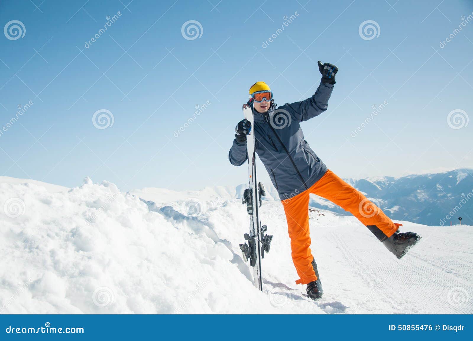 Happy skier sportsman at winter ski resort. Happy man skier at winter ski resort