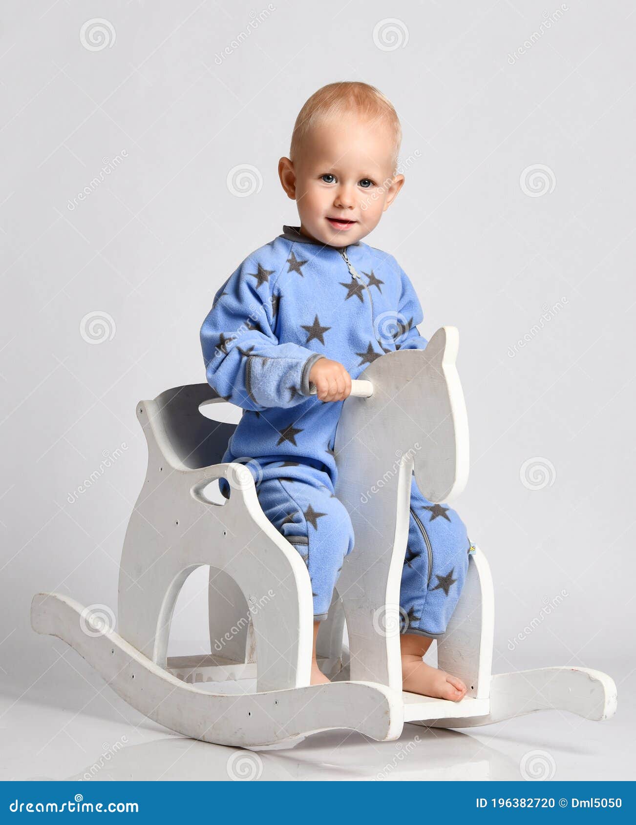 Calm Barefooted Blond Baby Boy Toddler in Blue Fleece Jumpsuit with Stars  Sits on the Floor Leaning on His Arm Stock Image - Image of cute, friend:  196382725