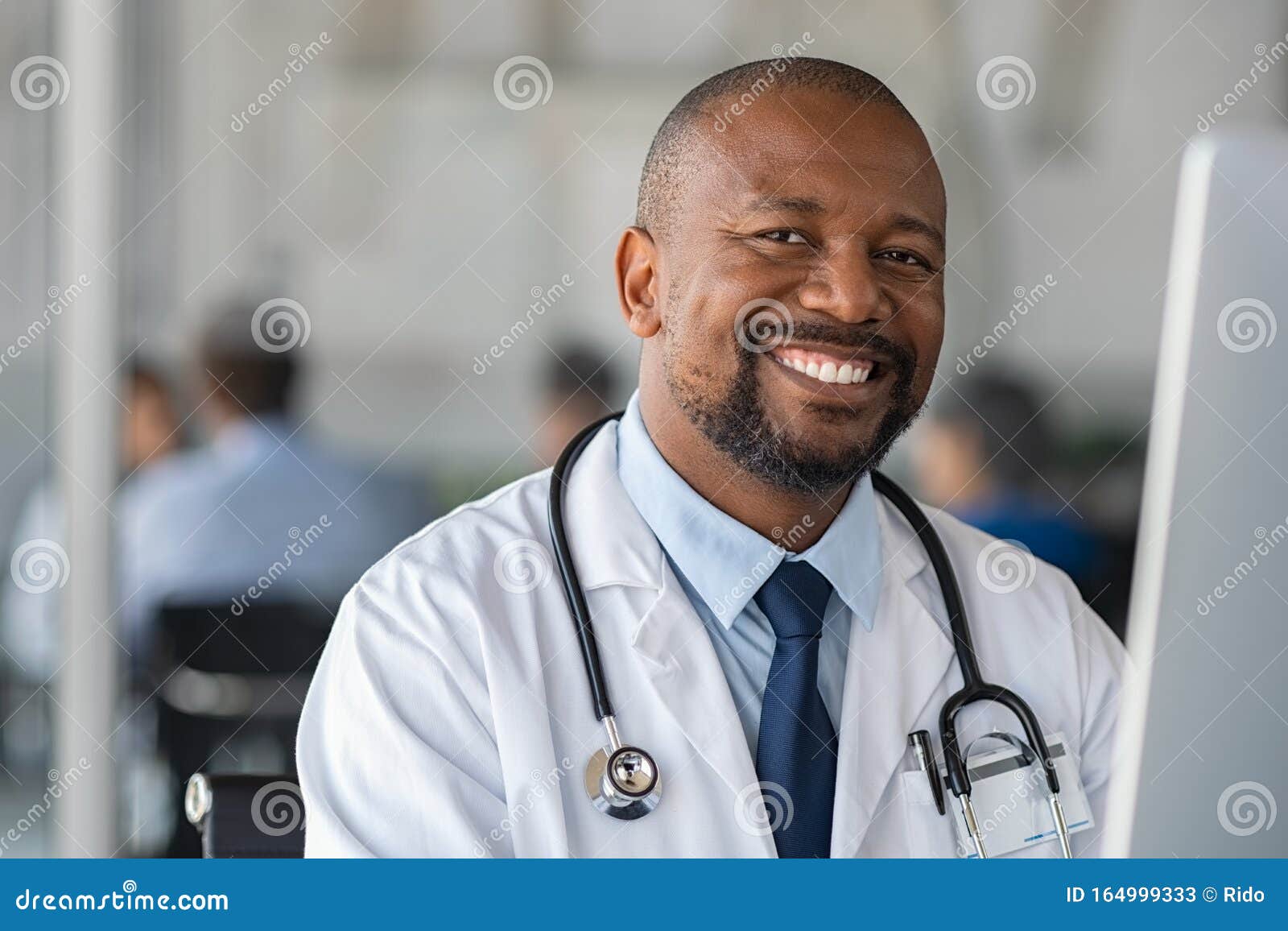 happy smiling black doctor looking at camera