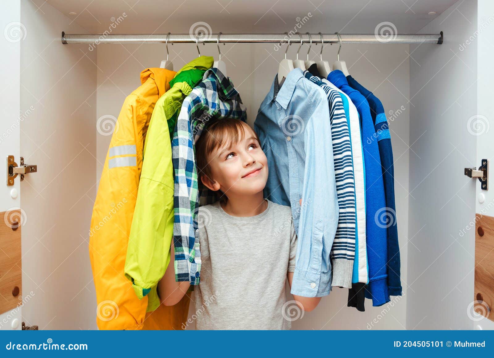 Preteen Boy Chooses Clothes in the Wardrobe Closet at Home. Kid Hiding ...