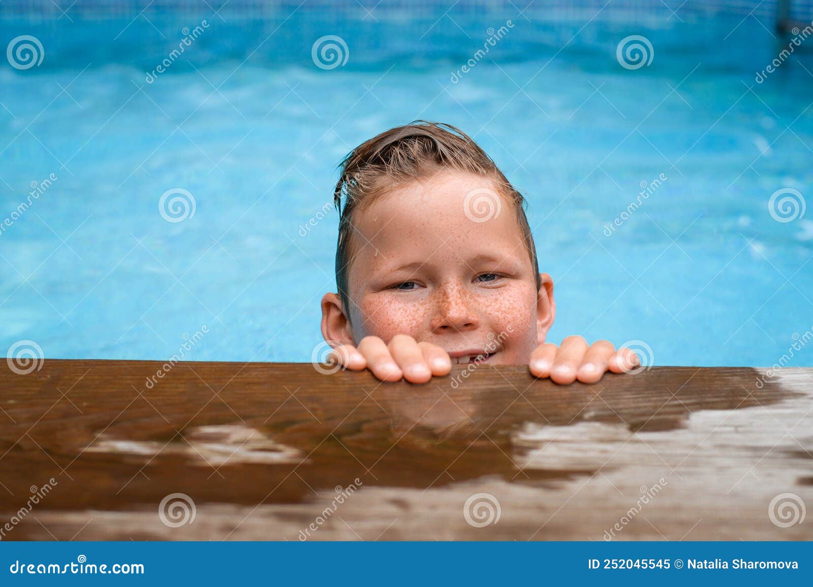Happy Smiling Boy in Swimming Pool in Summer Vacation. Child Portrait