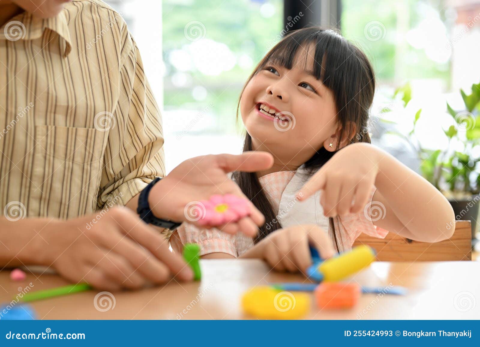 Happy And Smiling Cute Young Asian Girl Enjoy Playing Play Dough With
