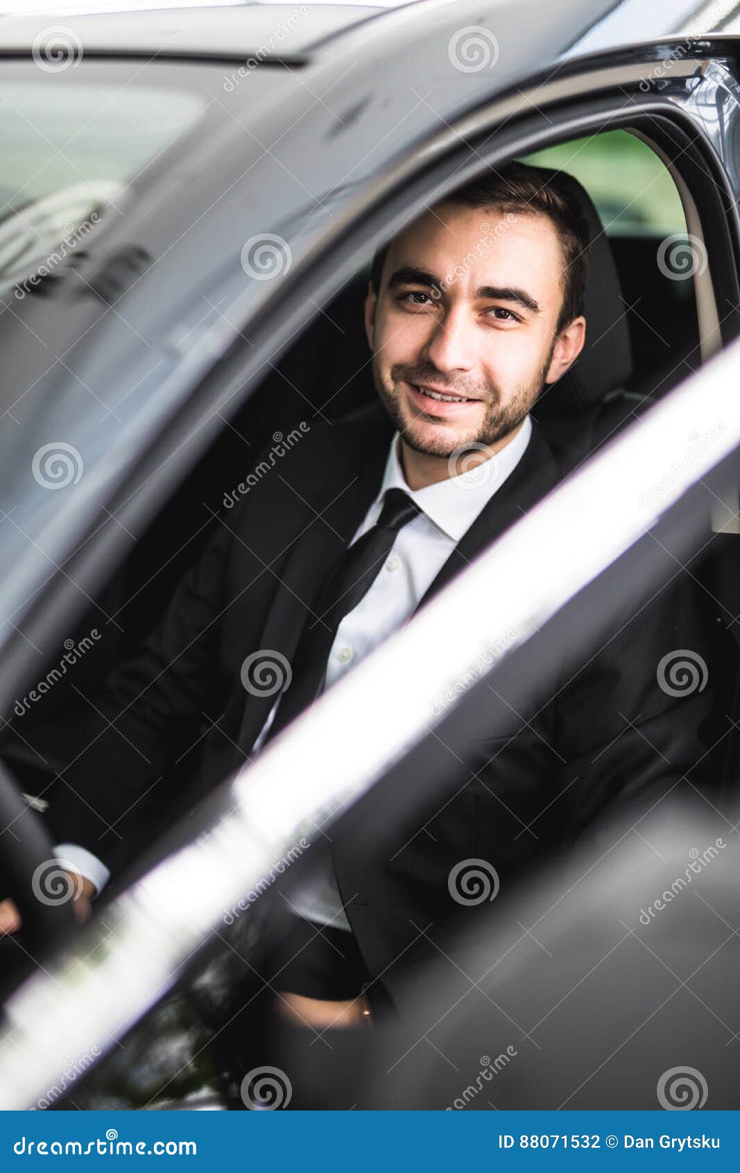 Happy smiling driver in the car open door
