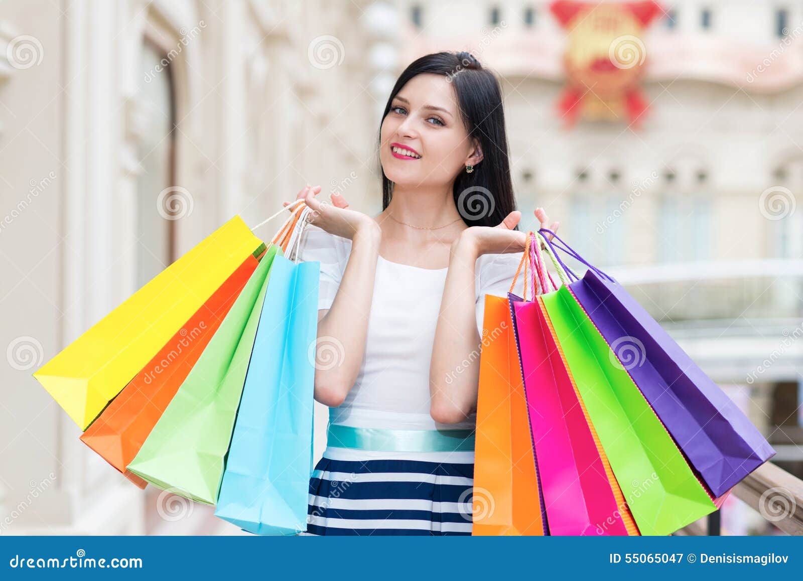 Full-length happy smiling lady with a lot of colourful shopping bags from  the fancy shops. Luxury shopping venue. Stock Photo by ©denisismagilov  74600157