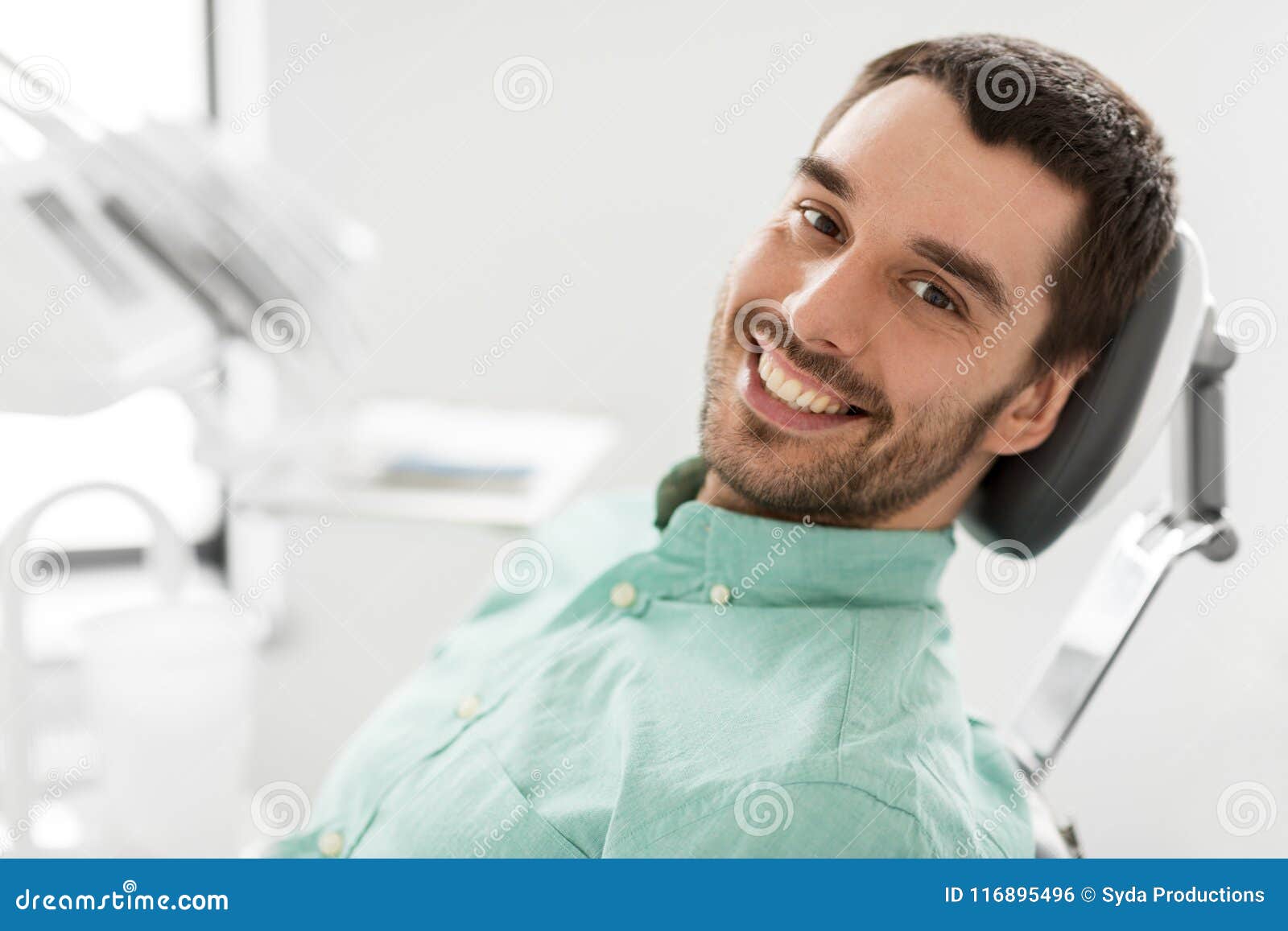 happy smiling male patient at dental clinic