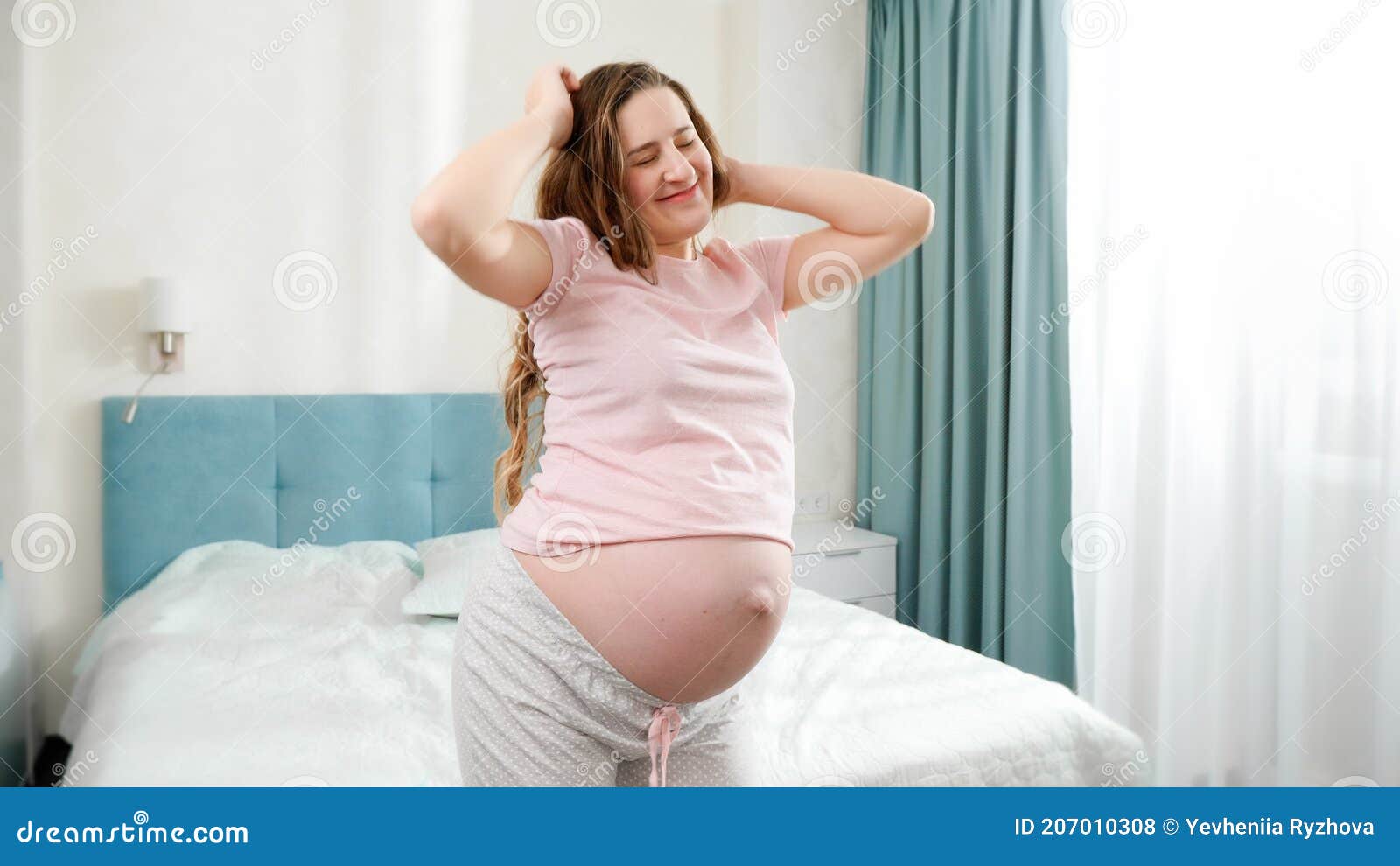 Carefree pregnant woman listening to music in city - a Royalty Free Stock  Photo from Photocase