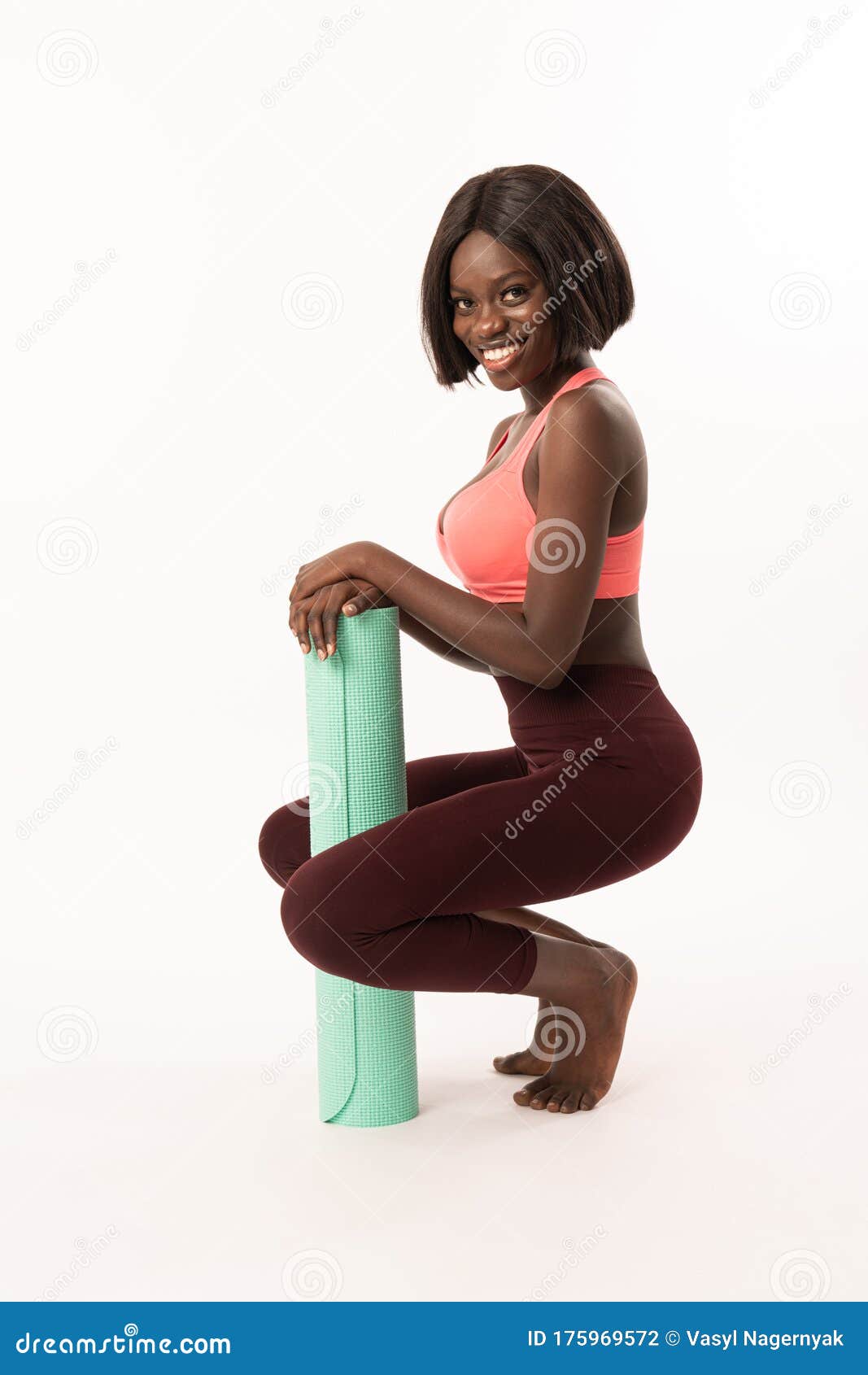 Happy Smiling Slim African Girl Crouched and Leaned on Blue Yoga