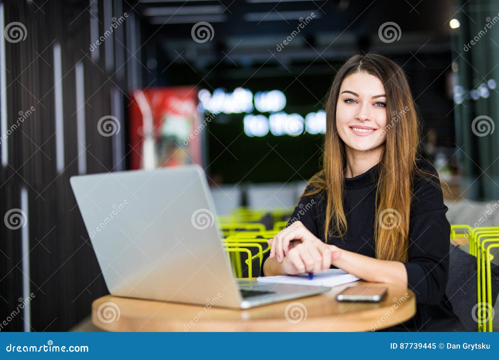 happy smiling woman working with laptop in modern smart space hub