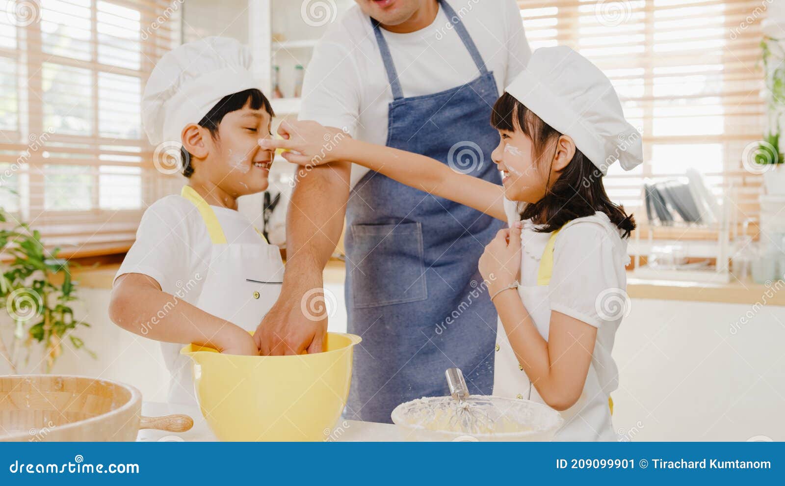 Happy Smiling Young Asian Japanese Family with Preschool Kids Have Fun Play and Laugh while Cook Cake for Breakfast Meal in Modern Stock Image