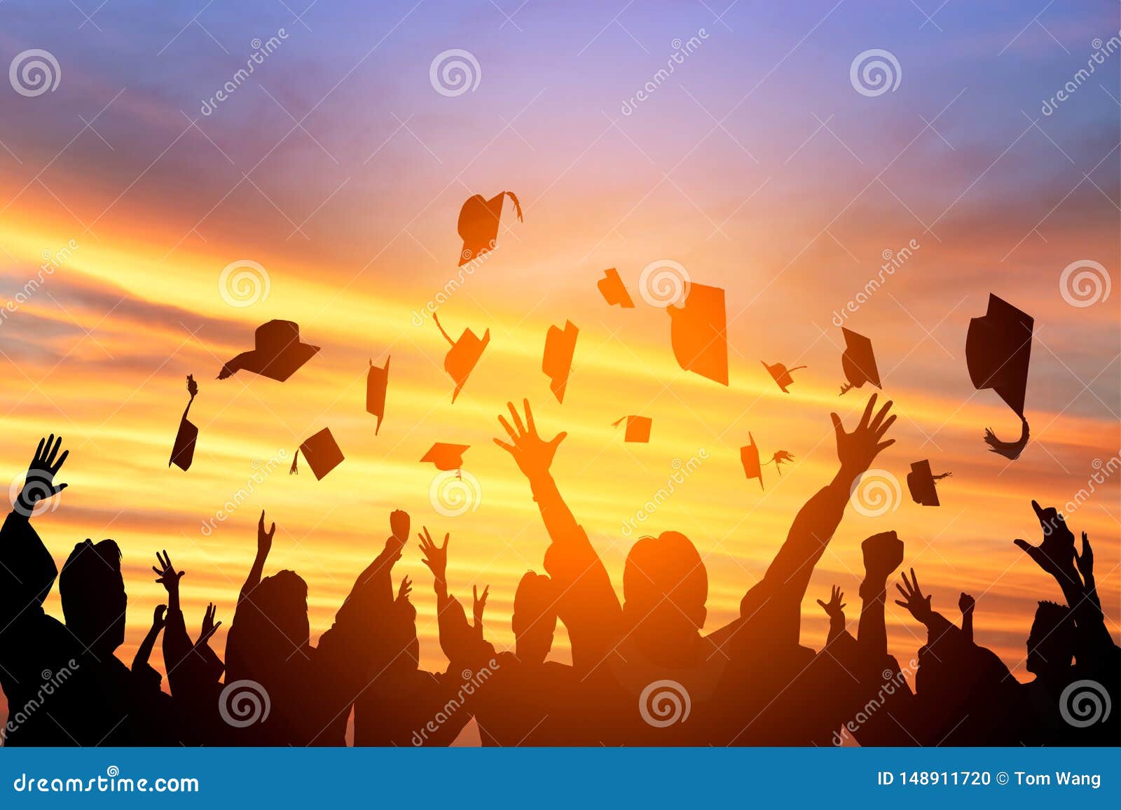 students throwing graduation caps in the air