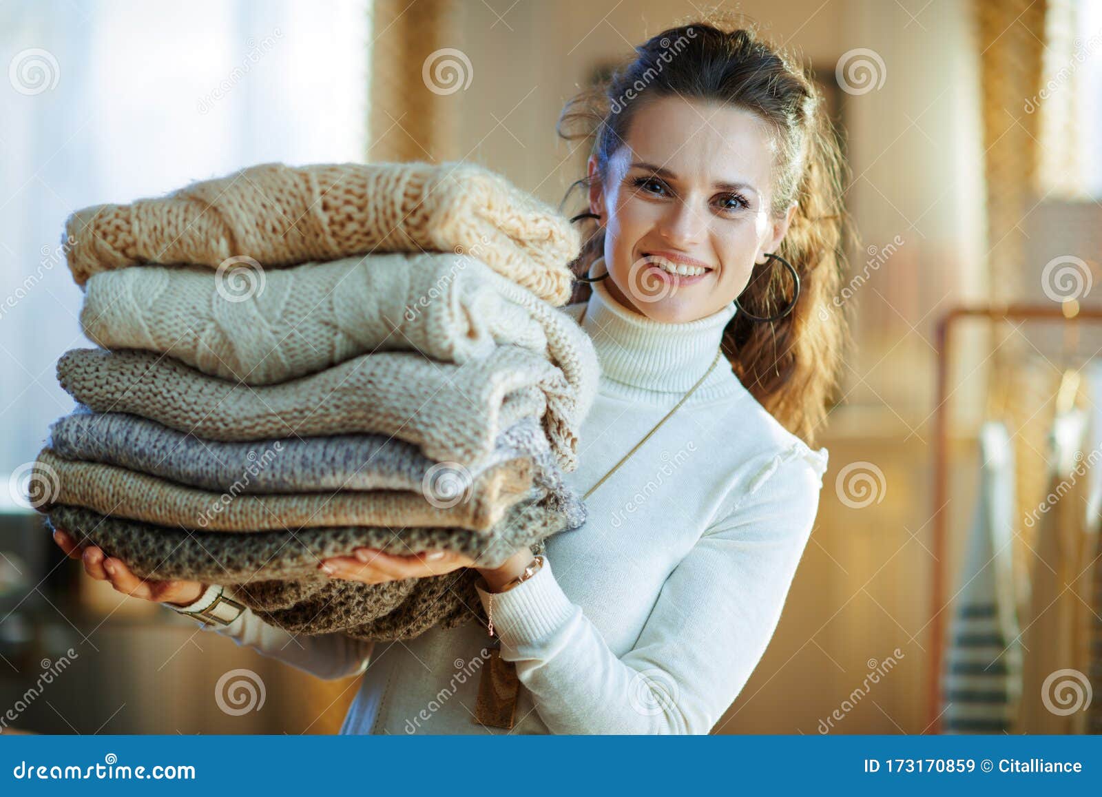 Happy Stylish Female Showing Pile of Sweaters Stock Image - Image of ...