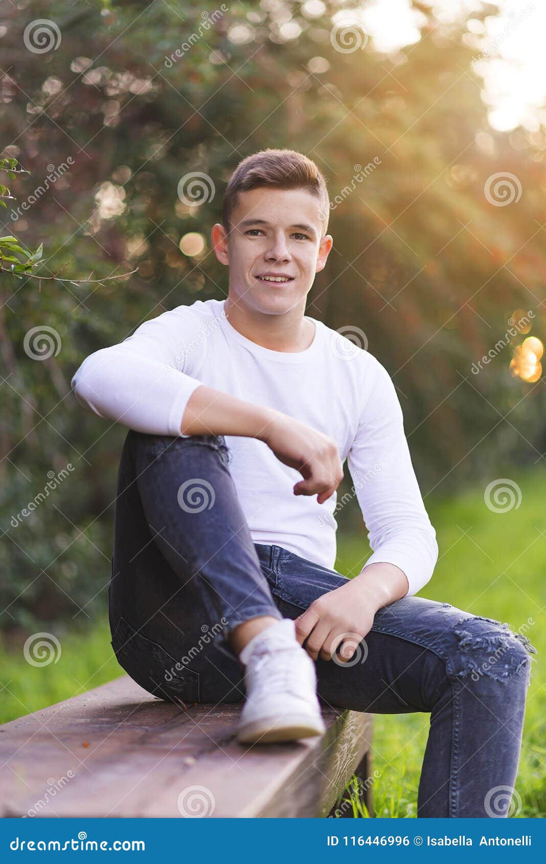 Stylish Teenager Sitting on a Wooden Bench on a City Park Stock Photo ...