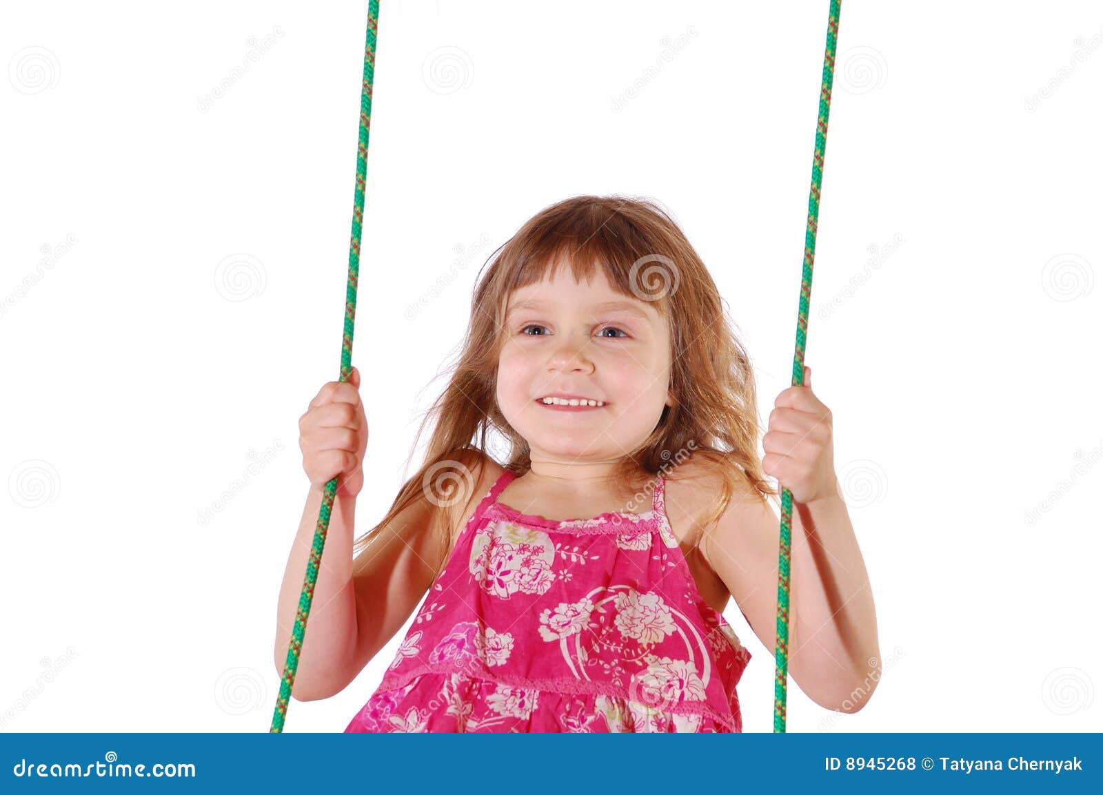 Happy swinging. A happy little girl wearing a dress swinging. Isolated. High key.