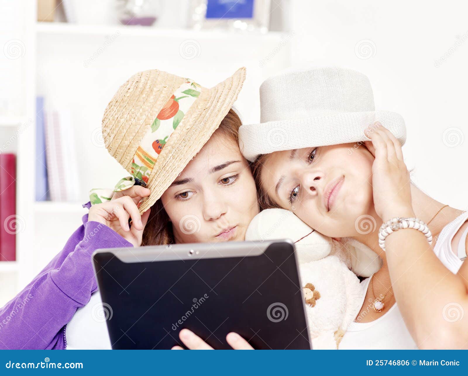 happy teenage girls having fun using touchpad