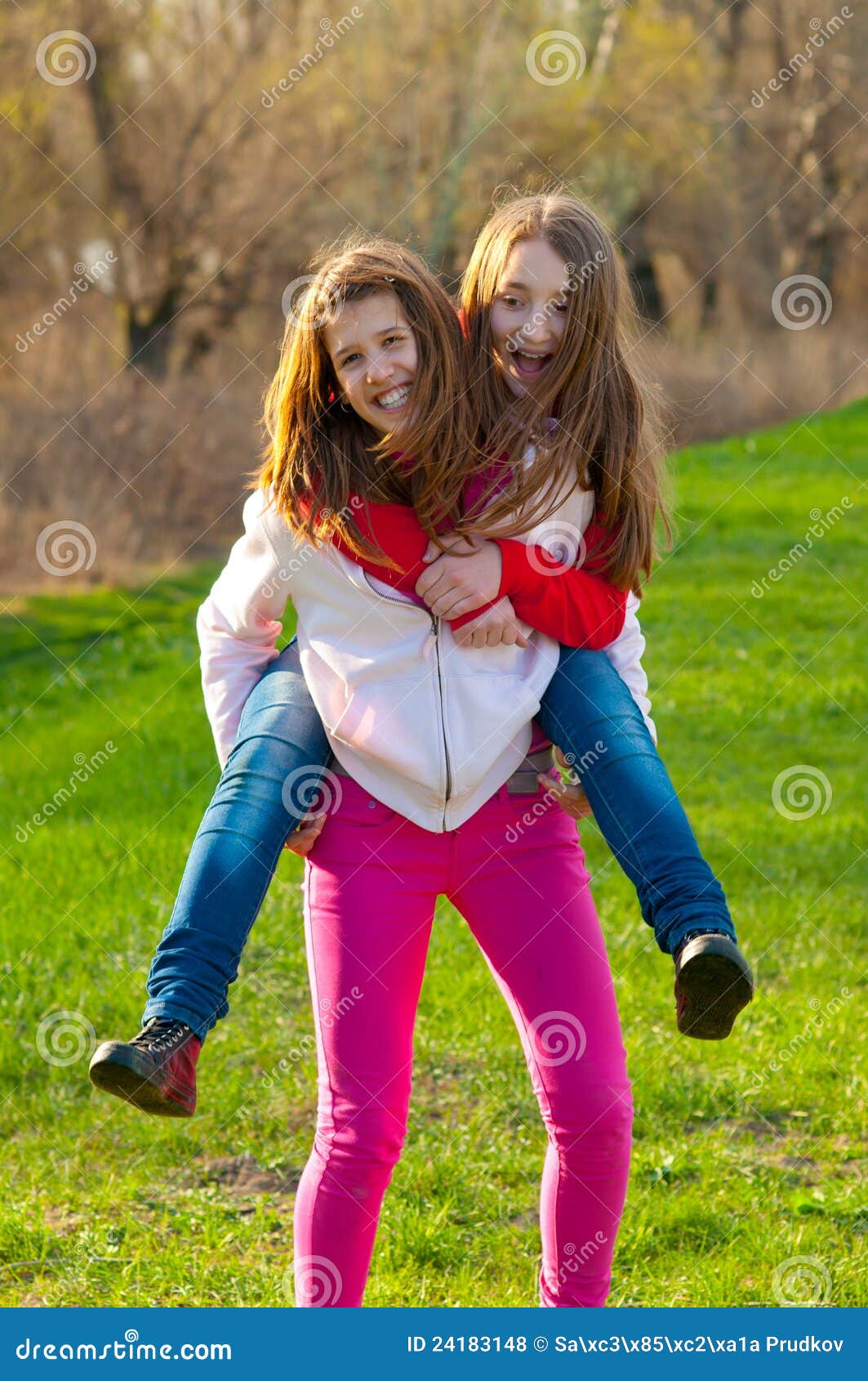 Happy Teenage Girls Piggy Back Riding on Meadow Stock Photo - Image of ...