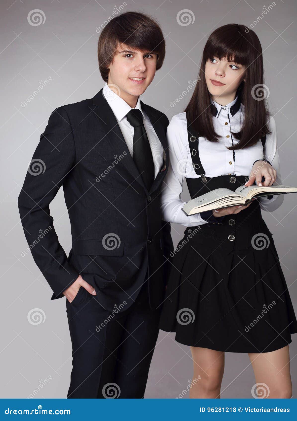 happy teenagers school uniform portrait handsome boy bea beautiful brunette girl posing isolated studio background 96281218