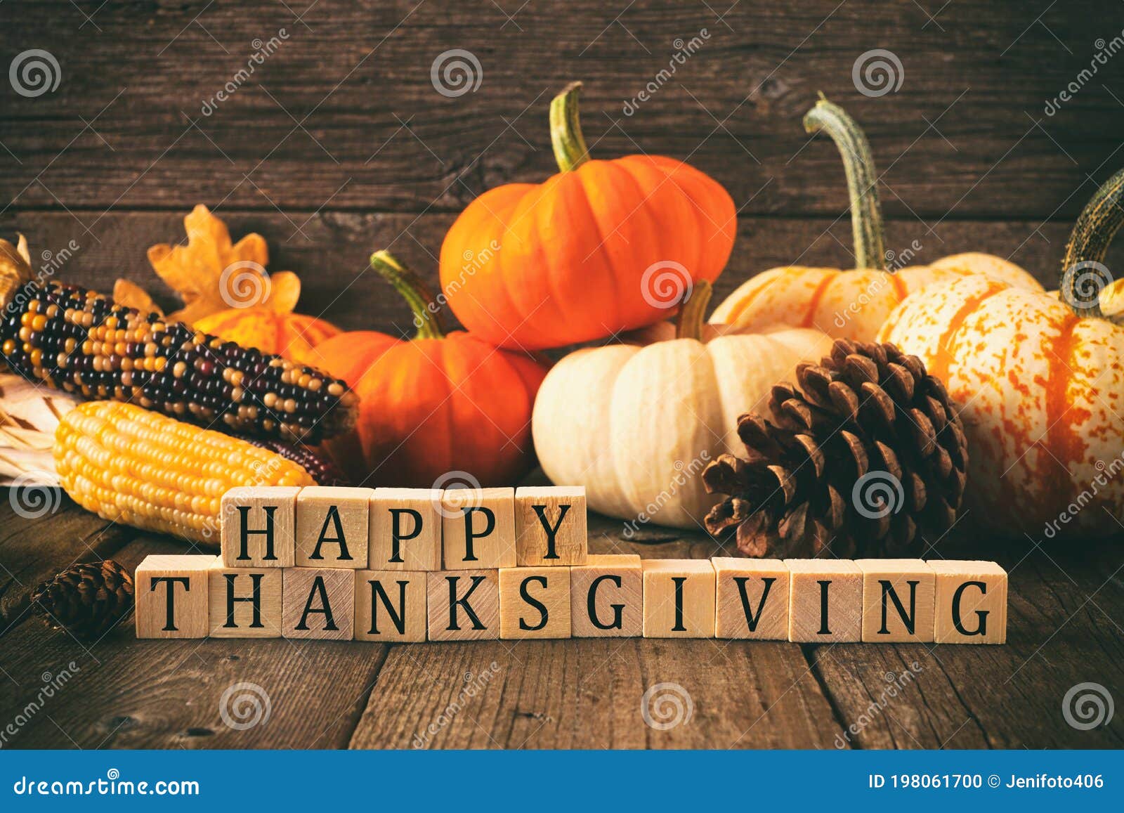 happy thanksgiving greeting against rustic wood with pumpkins and autumn decor. vintage style.