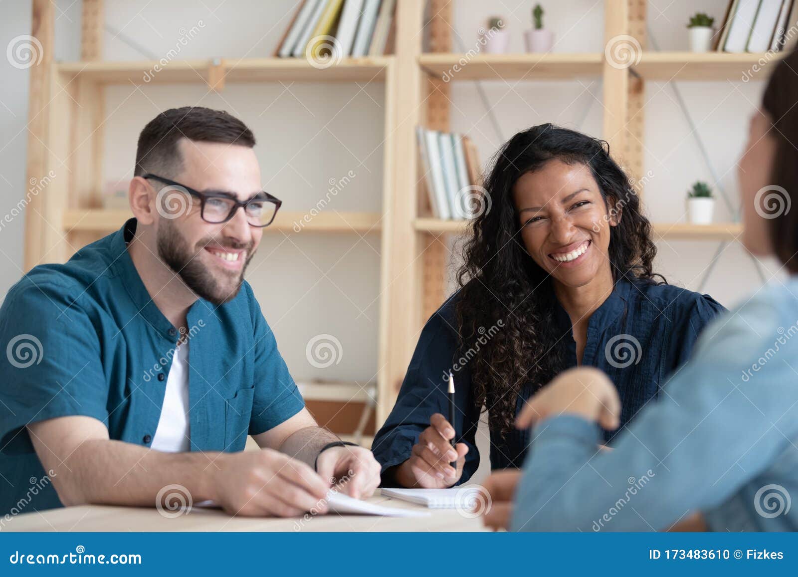 happy two diverse hr managers listening to funny job applicant.