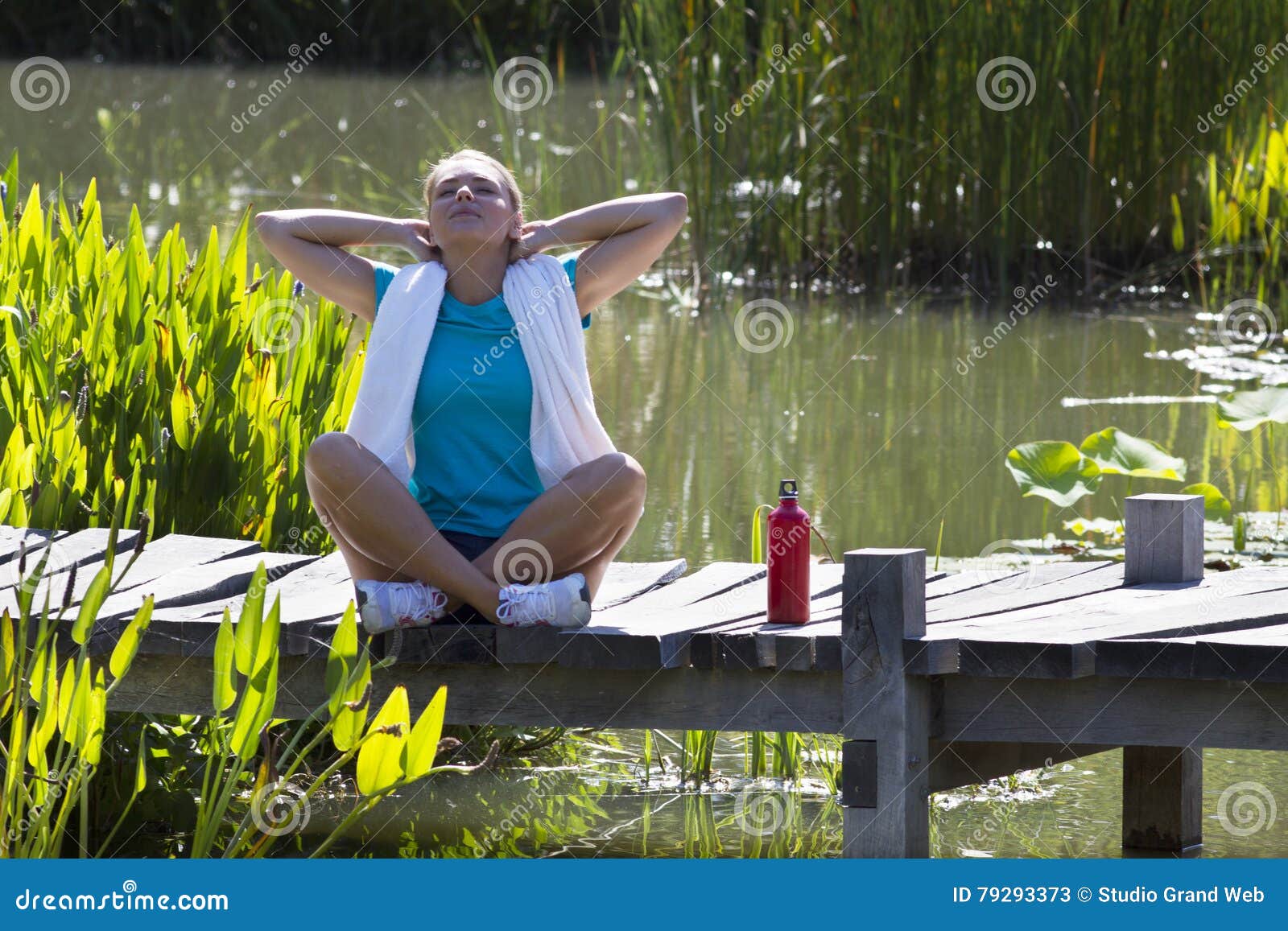happy woman breathing for openness and healthy wellbeing over water