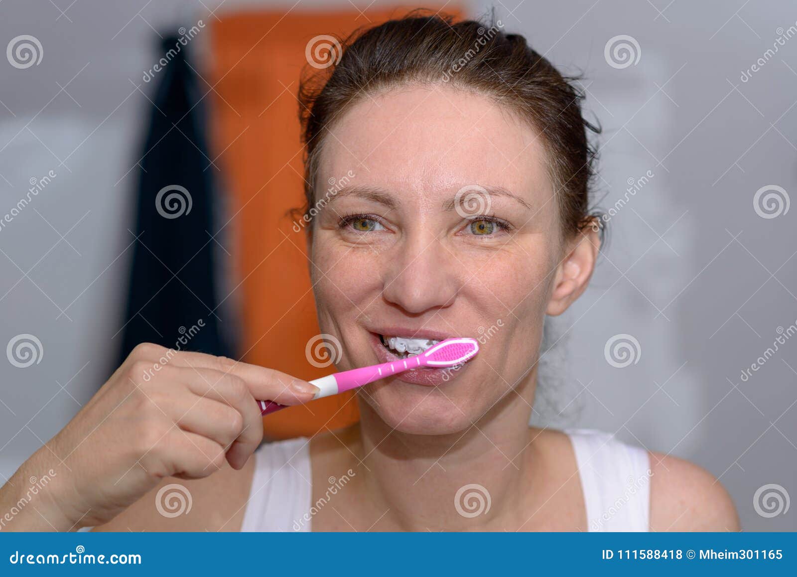 Happy Woman Brushing Her Teeth With A Toothbrush Stock Photo I