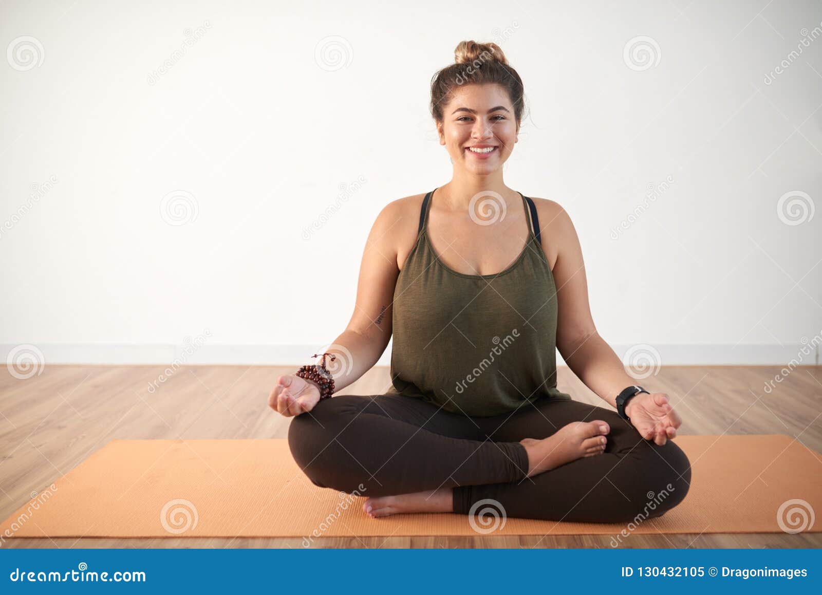 Beautiful young plus size woman meditating on yoga mat with her eyes closed  Stock Photo - Alamy