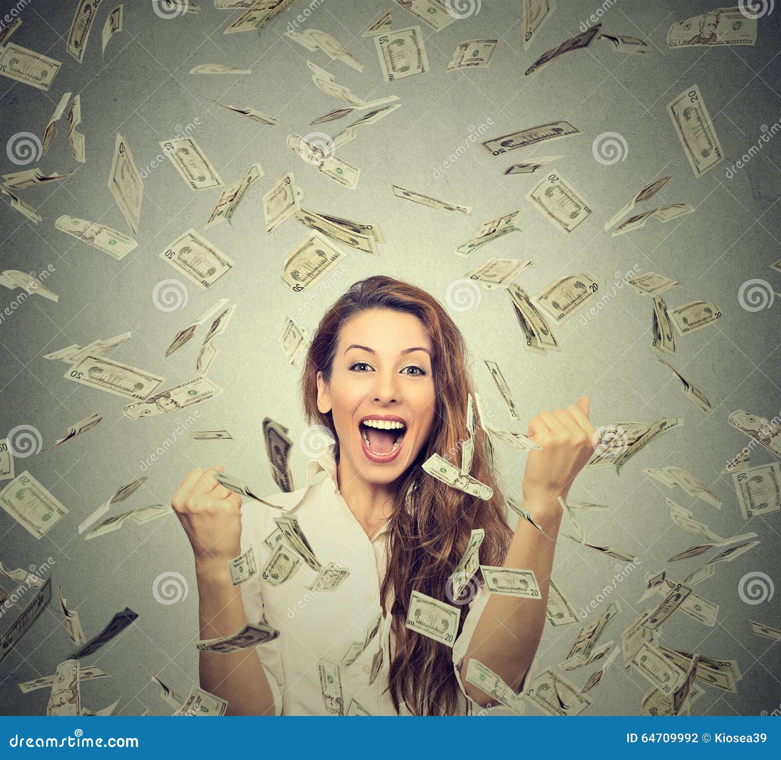happy woman exults pumping fists ecstatic celebrates success under a money rain