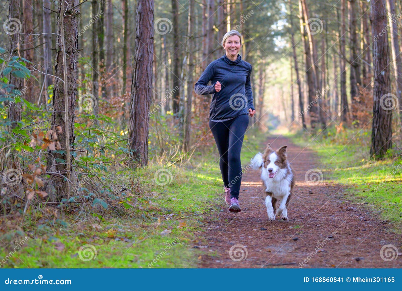 happy woman full of vitality exercising her dog