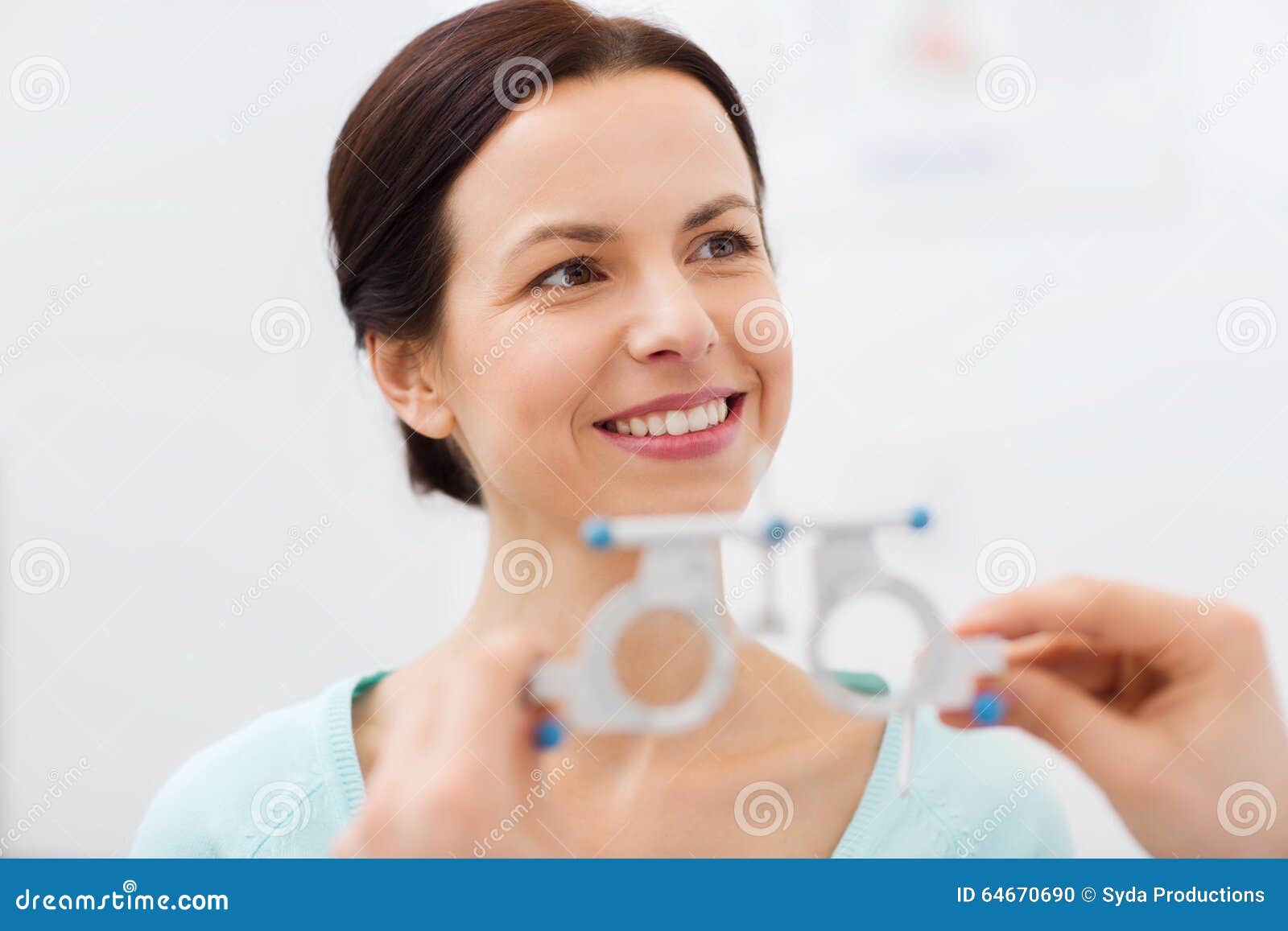 happy woman having vision test at eye clinic