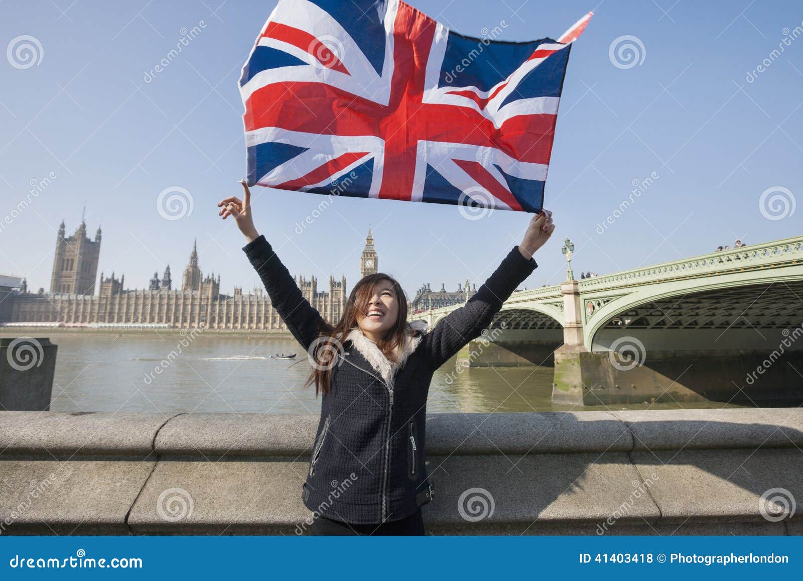 Happy Woman Holding British Flag While Standing Against ...
