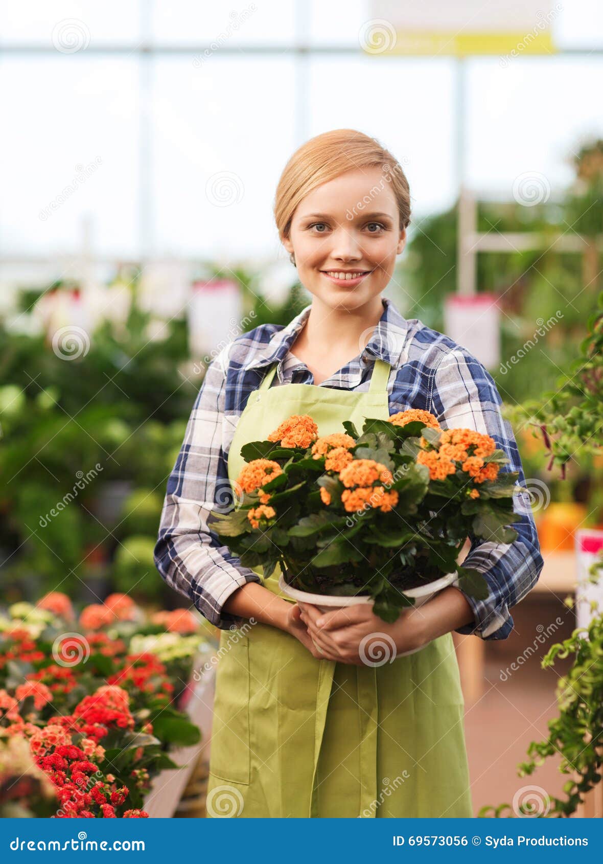 happy woman holding flowers greenhouse people gardening profession concept gardener 69573056
