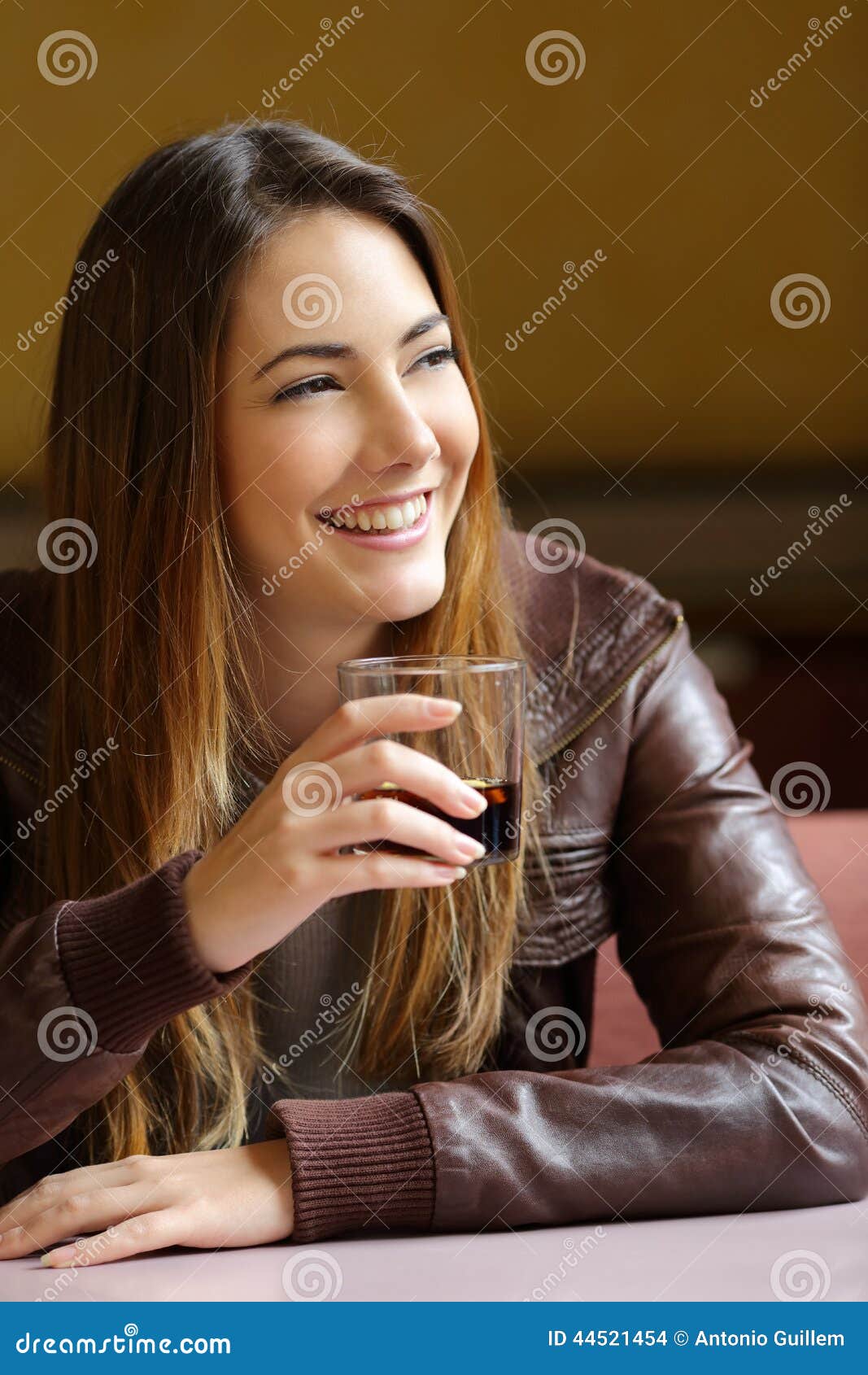 happy woman holding a refreshment in a restaurant