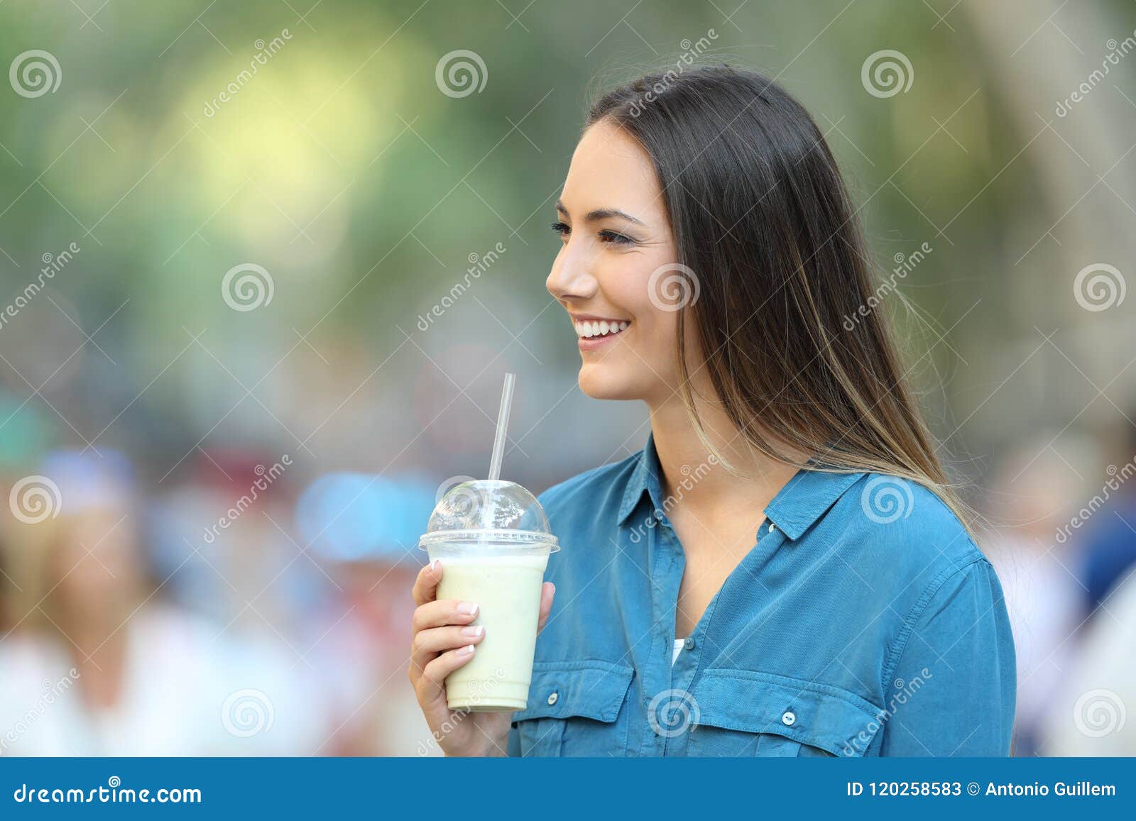 Happy Woman Holding a Smoothie Looking at Side Stock Image - Image of ...