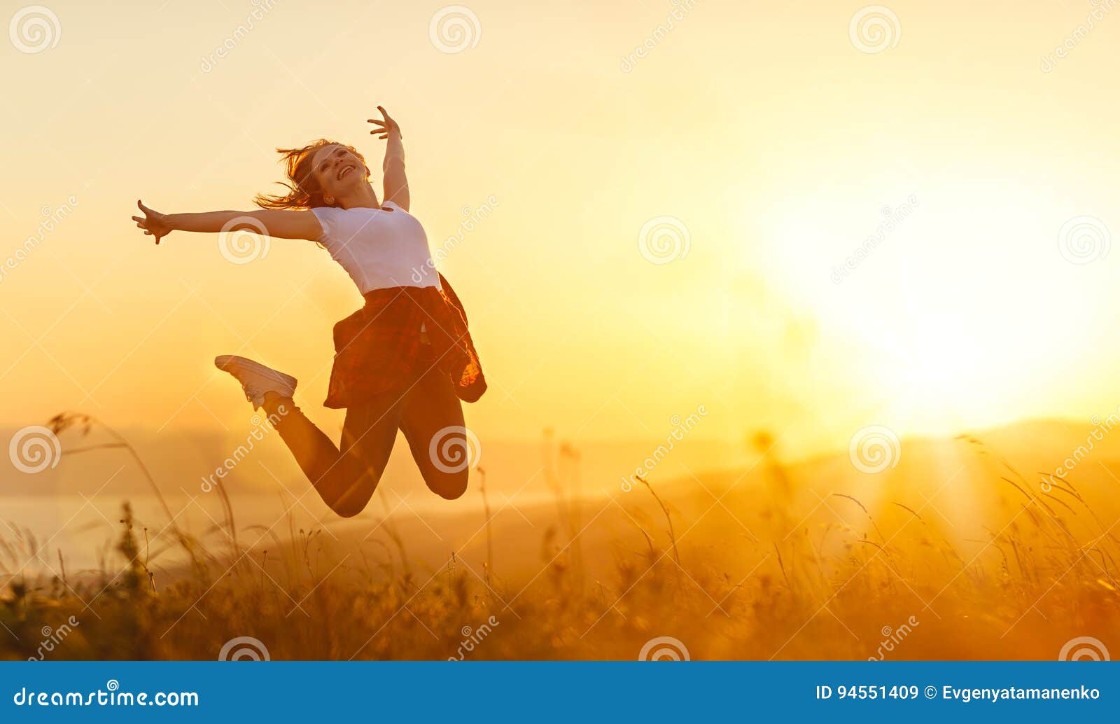happy woman jump, rejoices, on sunset in nature