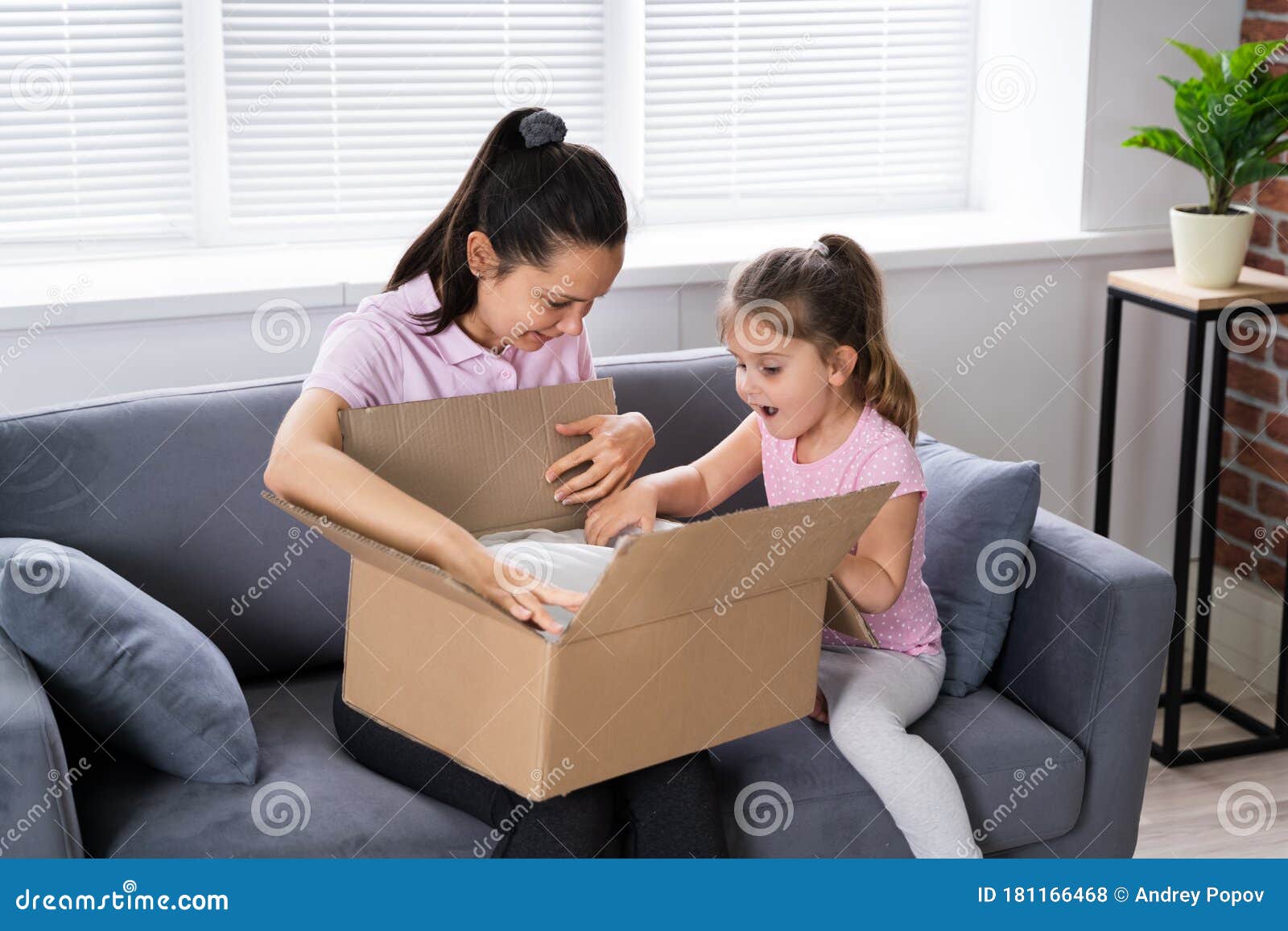 happy woman and kid opening received package