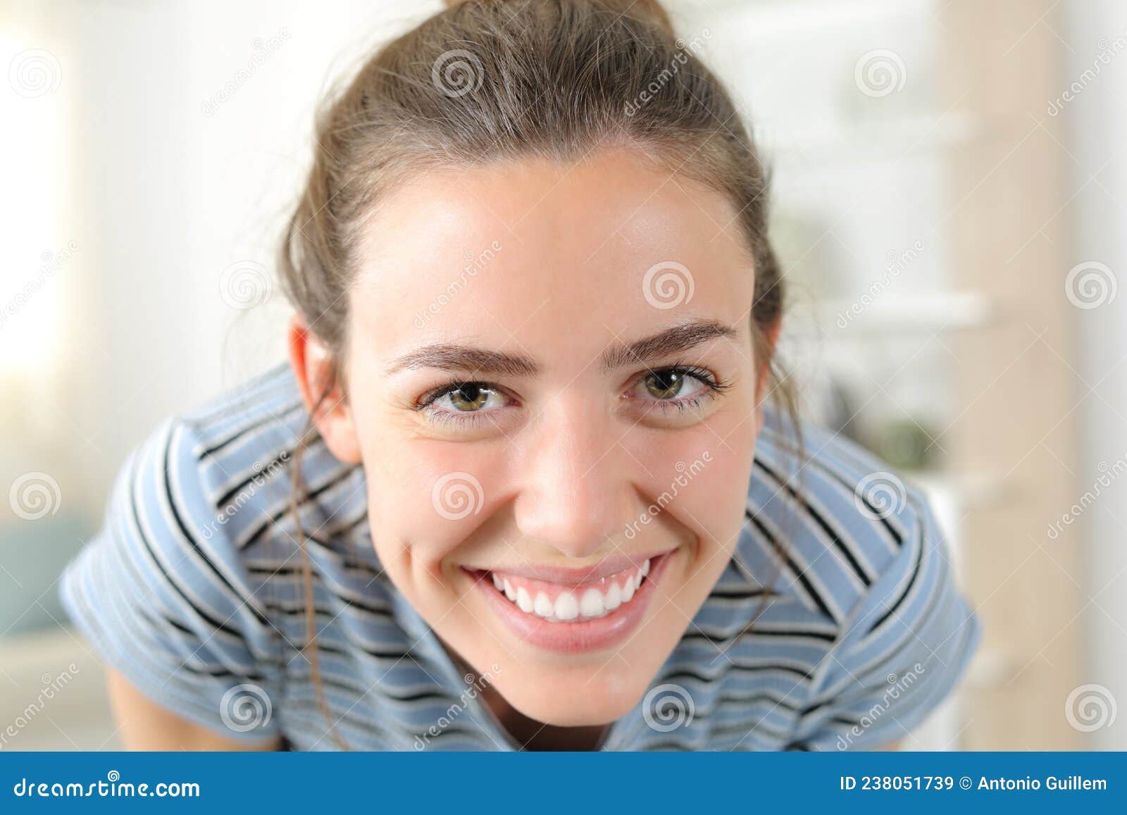 happy woman looking at camera joking at home