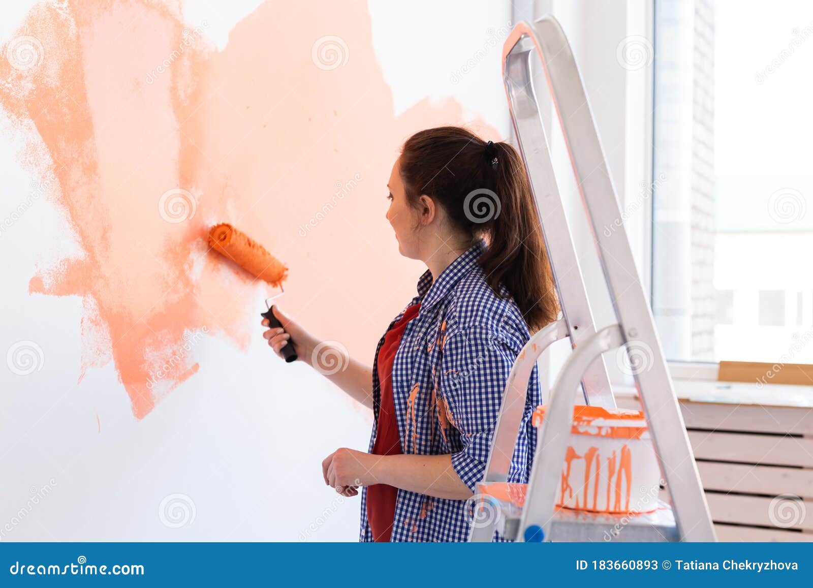 Happy Young Woman Painting Interior Wall With Paint Roller In New House. A Woman With Roller ...