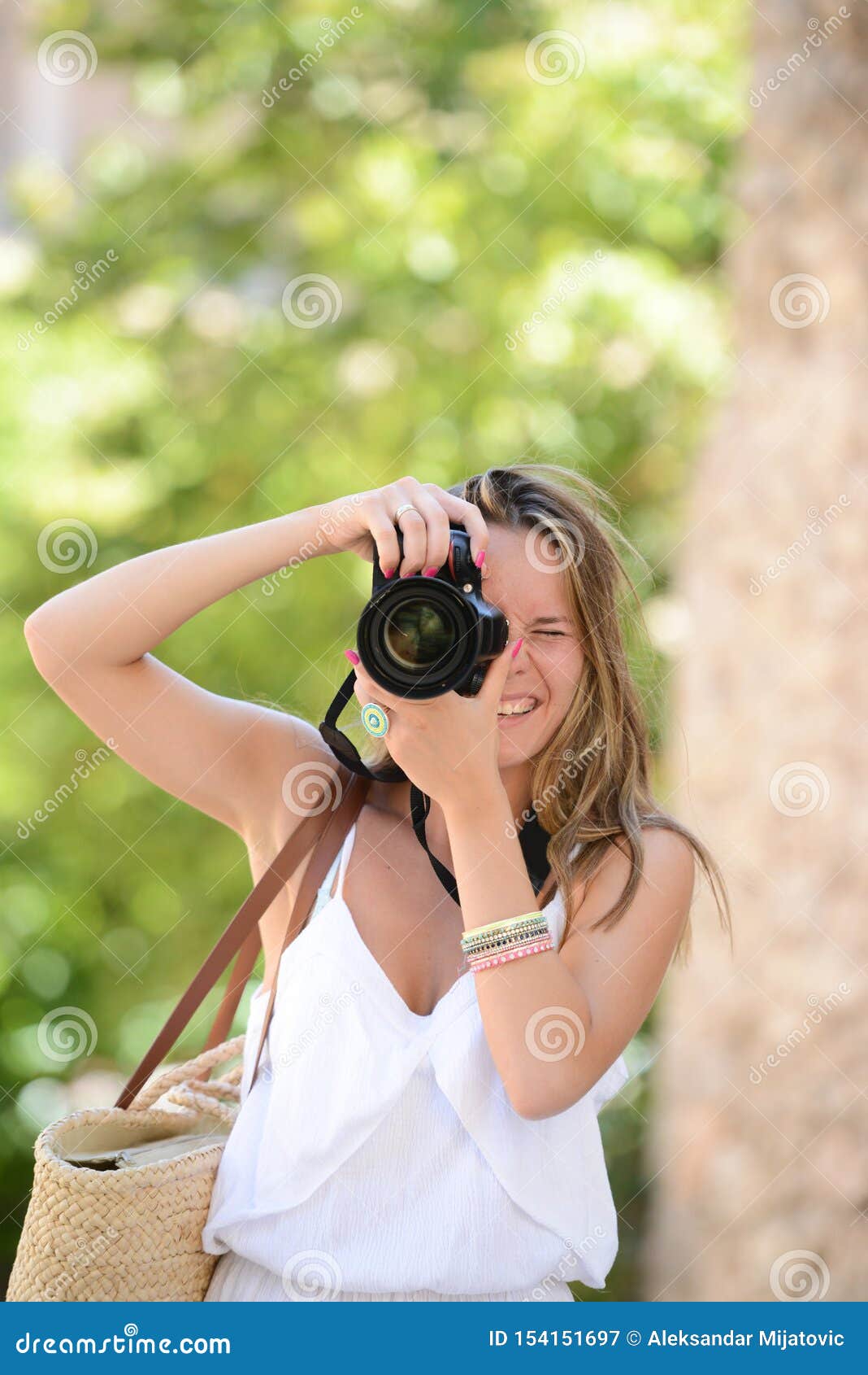 Happy Woman Photographer Holding A Dslr Camera Stock Image