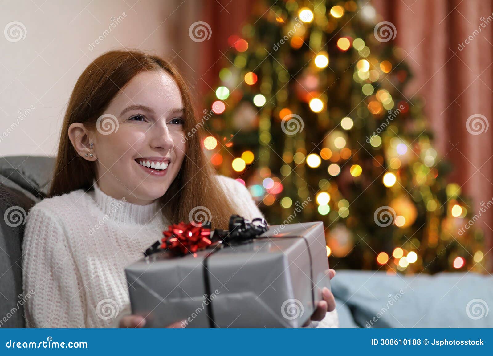 happy woman receiving a present at christmas