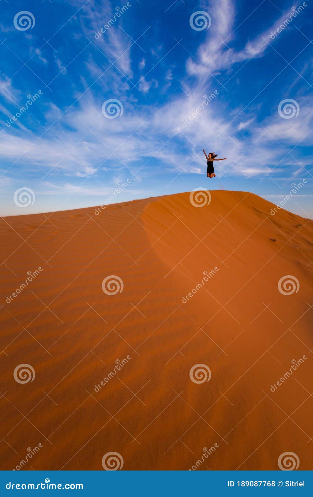 happy woman on red sand dunes in vietnam