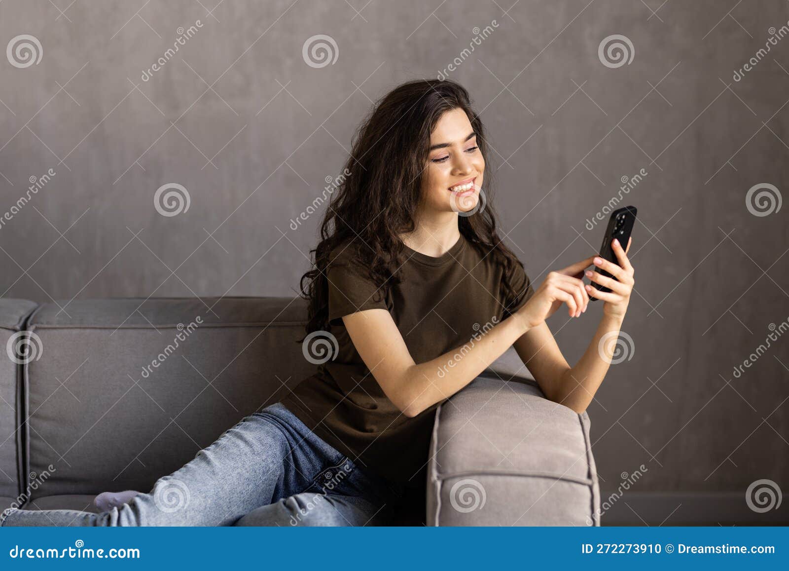 happy woman relaxing on comfortable sofa, enjoying web surfing information in internet or using mobile software application,