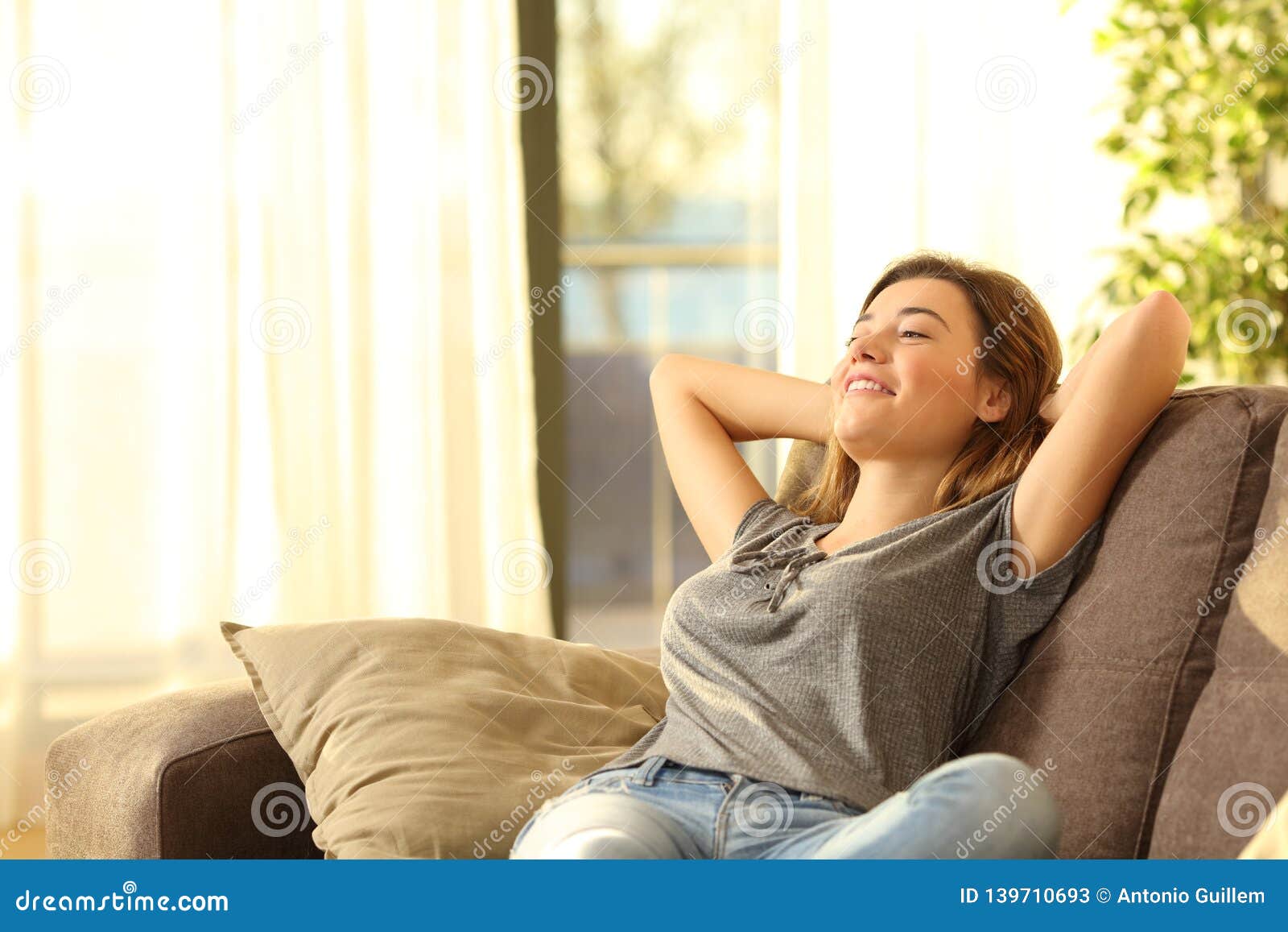 happy woman resting comfortably at home