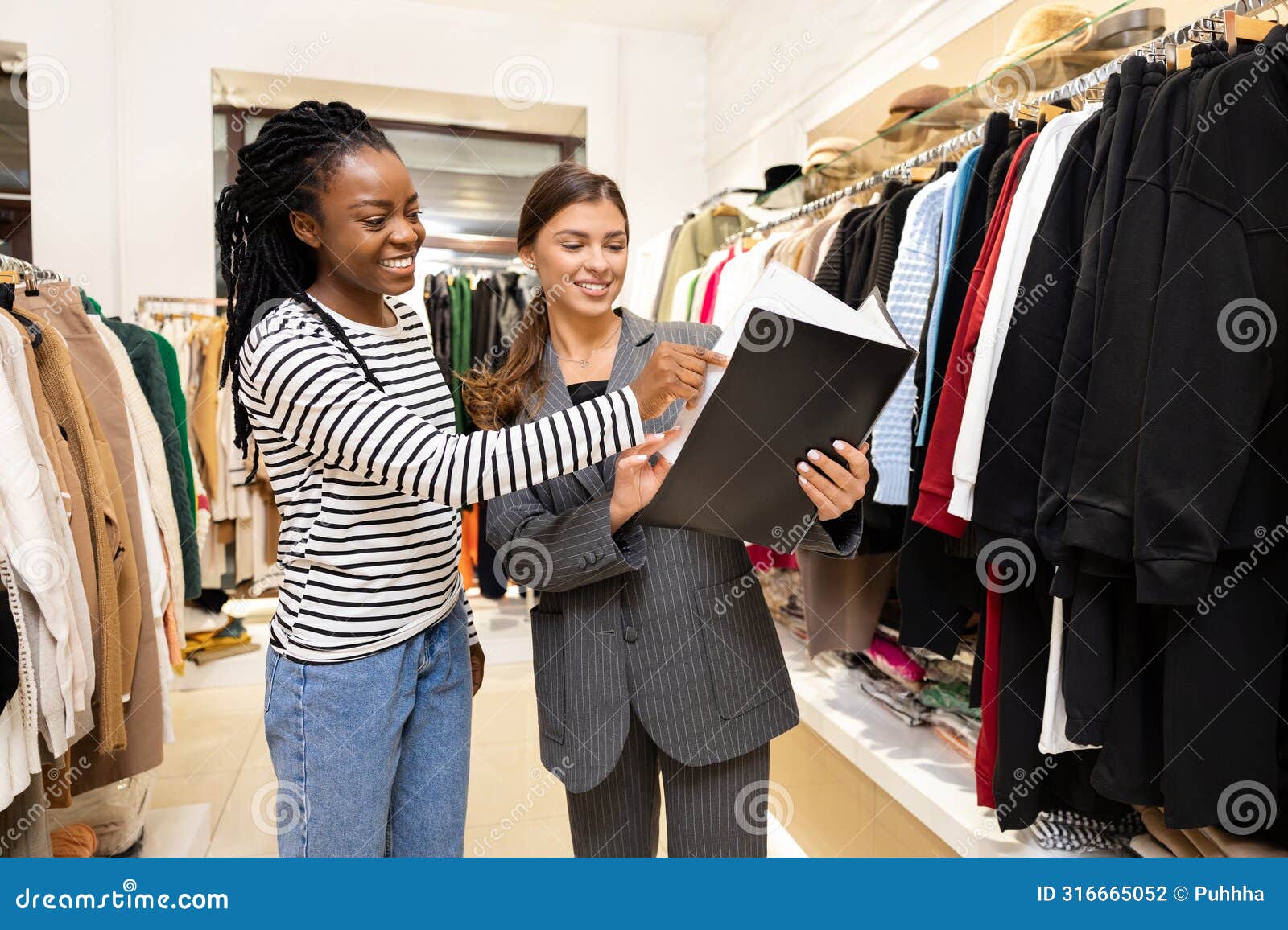 happy woman shopping with consultant in a fashion store