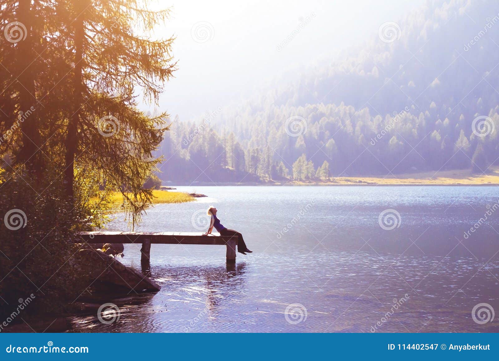 happy woman sitting on the pier and smiling, happiness or inspiration concept