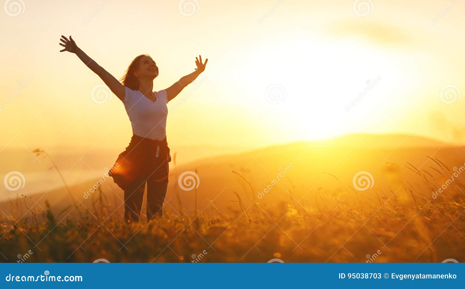 happy woman on sunset in nature iwith open hands